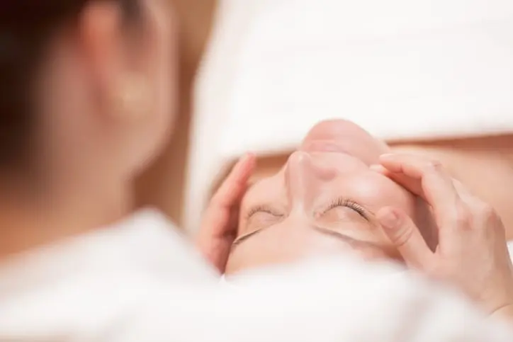 Young Woman Receiving Facial Massage In Spa